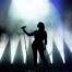 Silhouette of singer on the stage holding a microphone