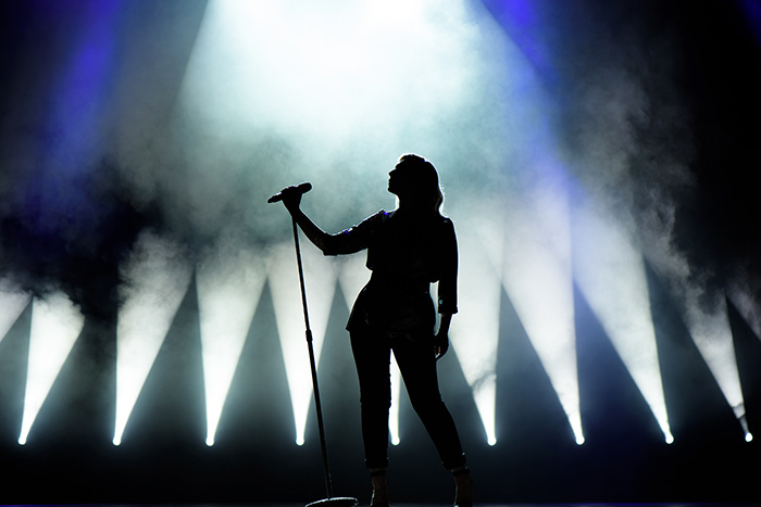 Silhouette of singer on the stage holding a microphone