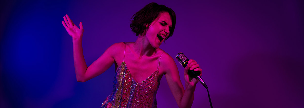 Woman singing with neon colorful background