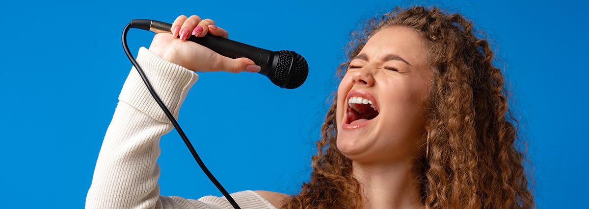 Woman with curled hair hitting high notes