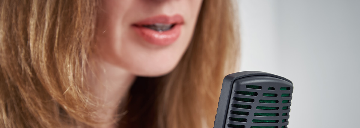 Close up of woman's mouth and microphone