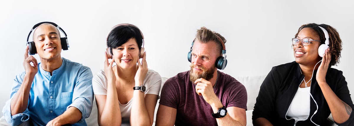 Four people listening to songs with headphones
