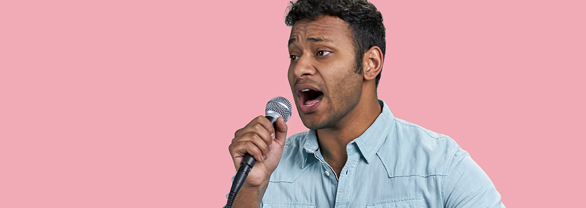 Male singer practising clear English pronunciation with microphone