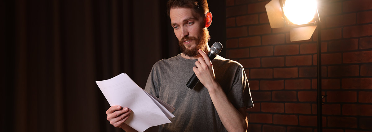 Male singer reading lyrics while practising