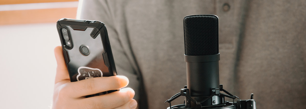 Singer using a smartphone and studio microphone to practise spoken and sung English